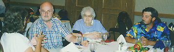 Members chat over a dining table