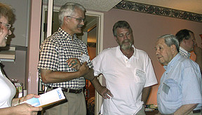 Several early birds stand in a circle chatting