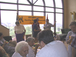 Several people at a table and on a stage