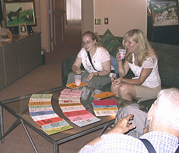 A few women at a table fill with papers