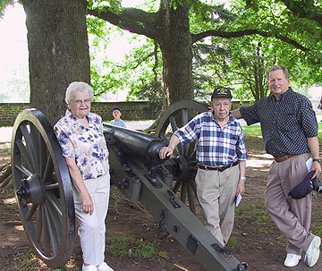 Evelyn, Virgil and Bill pose by a cannon
