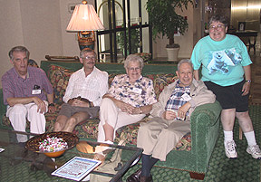 Five members posing on a couch