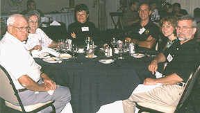 Several members reminiscing around a table