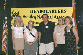 Five members in front of an HNA headquarters sign