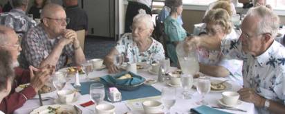 Members eating around a table