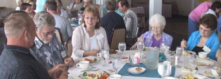 More members eating around a table