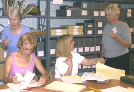 Several people looking through records