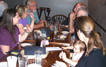 Another photo of people eating at a table