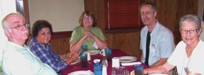 Another photo of people gathered around a table