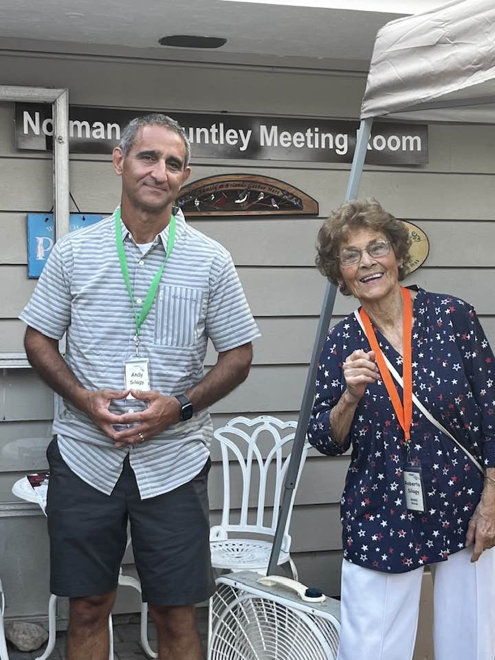 A man and a woman in front of the Norman Huntly Meeting Room