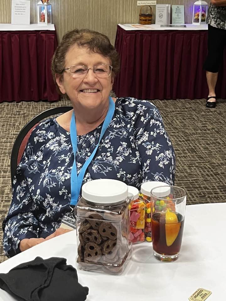 Woman at table with snacks and a drink