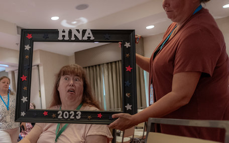 A woman makes a silly face with the frame
